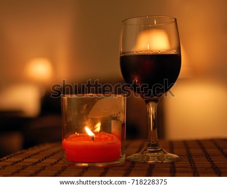 Glass of wine and a candle 