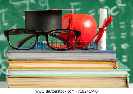 Apple Knowledge Symbol and Pencil Books on the desk with board background.Education concept school