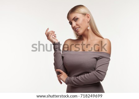 Young beautiful cute girl showing different emotions. Background for the girl a concrete gray wall