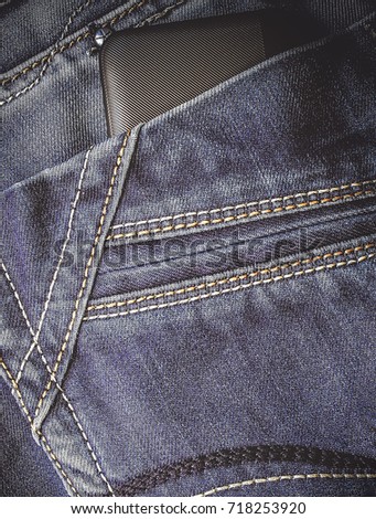 jeans. smartphone in the back pocket. vertically.  toned