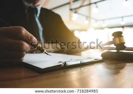 Real Estate concept, judge gavel / lawyer in auction with house model, dark color tone Royalty-Free Stock Photo #718284985