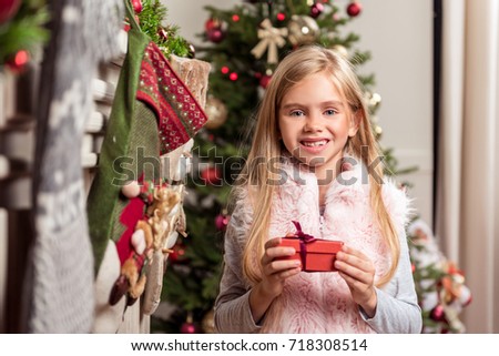Happy girl likes Christmas presents