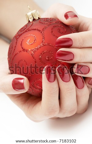 hands holding precious red Christmas globe