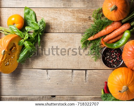 Group of vegetables - pumpkins, carrots, pepper and tomato over wooden texture. Copy space