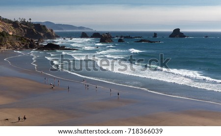 Tide At Indian Beach. Unidentified people walking around seashore in Indian beach of Ecola state park, Oregon, USA. Panoramic photo.