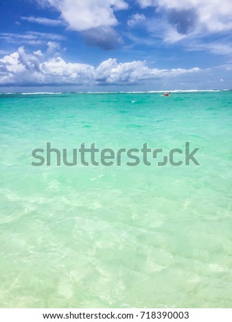 Scenic seascape of azure transparent ocean water and blue sky. Tropical beach with white sand. Idyllic scenery of seaside resort. Exotic travel destination for holiday and vacation. Sea background