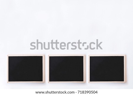 White office desk table with chalkboards. Top view with copy space, flat lay.