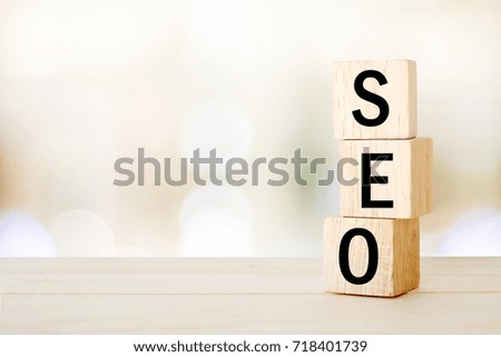 SEO, search engine optimization, on wooden cubes and blur bokeh background, business concept, digital marketing