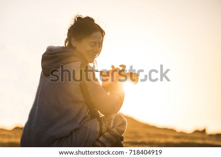 Girl photographing sunset
