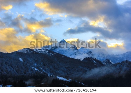 The sun sets over the Zugspitze and Alpspitze mountains in Garmisch-Partenkirchen, Germany.