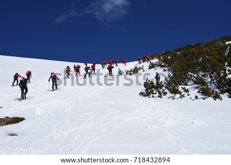 a group of skiers in the mountains