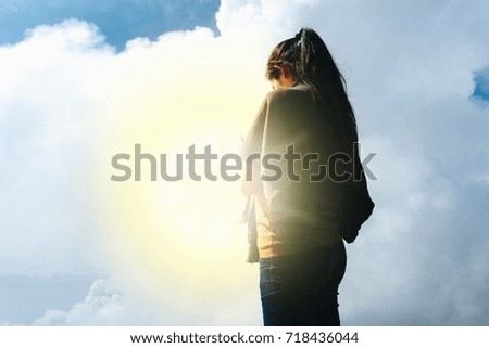 Young woman standing with sky background