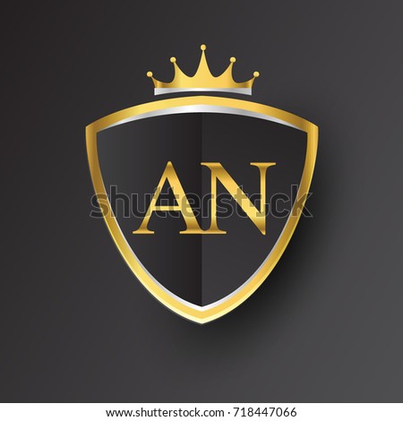 Initial logo letter AN with shield and crown Icon golden color isolated on black background, logotype design for company identity.