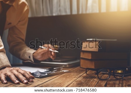 Lawyer working hard his job paperwork  at office, vintage picture style.