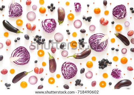 Composition of vegetables and fruits on a white background. Pattern made from fresh vegetables and fruits. Top view, flat design. Collage of red cabbage in a cut, eggplants, plums, grapes, mandarins. Royalty-Free Stock Photo #718490602