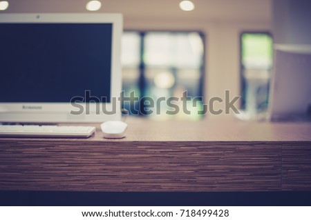 The white personal computer with the keyboard and the mouse on the wooden table ready to use for educational or business purposes