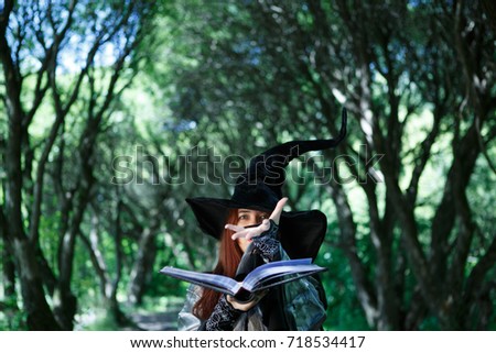 Photo of young witch in hat