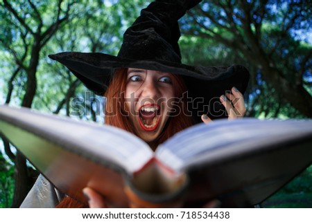 Portrait of witch with open magic book