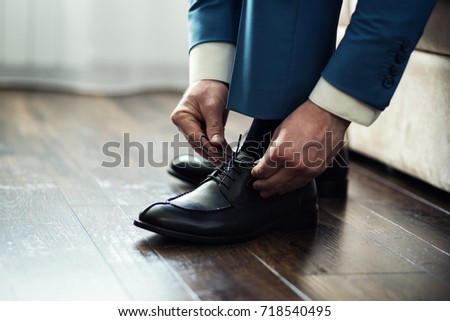 businessman clothes shoes, man getting ready for work,groom morning before wedding ceremony Royalty-Free Stock Photo #718540495