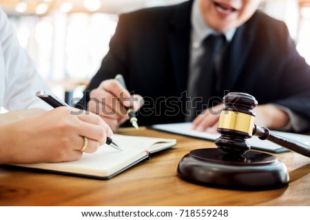 business people and lawyers discussing contract papers sitting at the table. Concepts of law, advice, legal services. Royalty-Free Stock Photo #718559248