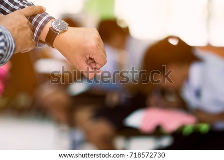 The examiners are watching the time in final test. Royalty-Free Stock Photo #718572730