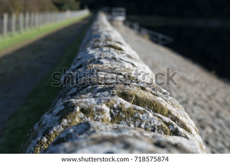 Top view of old stone wall running along side of reservoir