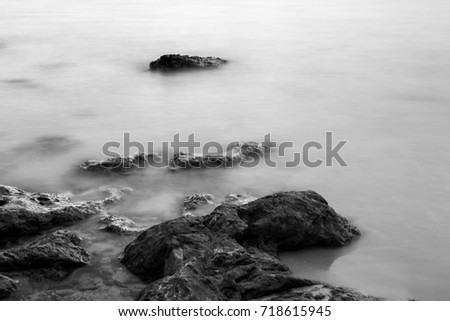 Long exposure, sea wave hit the rock at beach with blur motion abstract in black and white