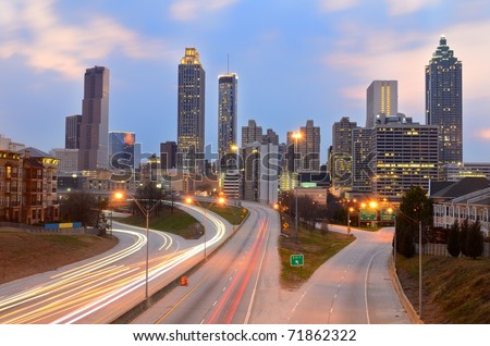 The skyline of Atlanta, Georgia above Freedom Parkway at night.