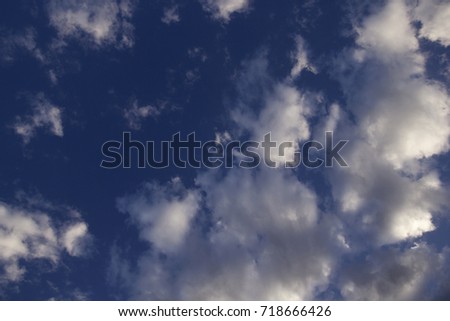 cumulus white clouds against a beautiful blue sky, bizarre patterns