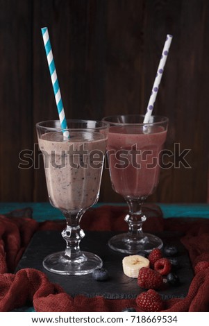Picture of two wineglasses with straws and smoothies
