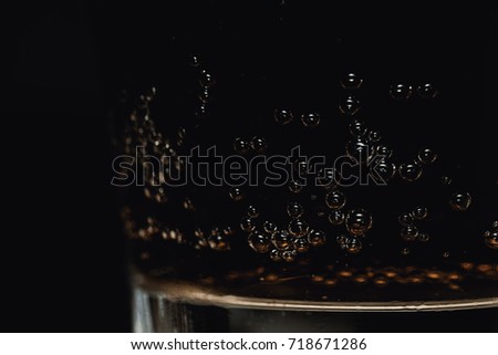 Close-Up Of Refreshing Glass Of Cola Fizzy Drink With Detailed Bubbles On Dark Background
