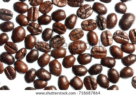 Close up image of coffee beans isolated on white background, picture decor for coffeehouse, scattered grain, dark roasted seed