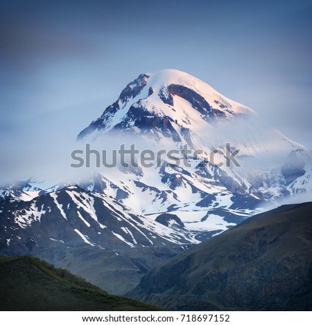 view to caucasus mountain dome through clouds in the morning in Georgia