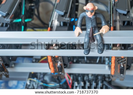 Bald plasticine man with a pickaxe mines cryptocurrency sitting on mining farm