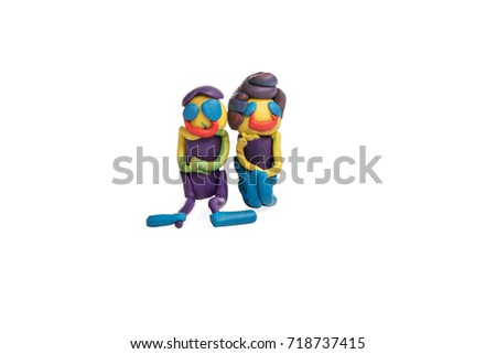 Two cheerful people - man and woman sitting side by side made of plasticine isolated on white background