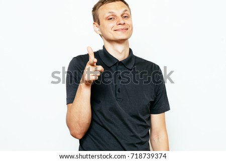 Young man showing his index finger towards the camera