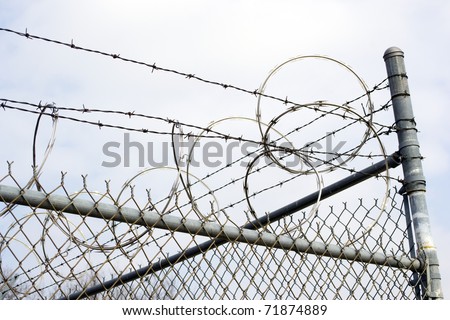 Razor Wire on Chain Link Fence Royalty-Free Stock Photo #71874889