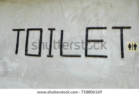 Men and women toilet sign on cement background. 