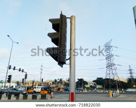 Traffic light pole on busy street
