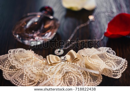 The garter of the bride lies on the table, wedding lace Royalty-Free Stock Photo #718822438