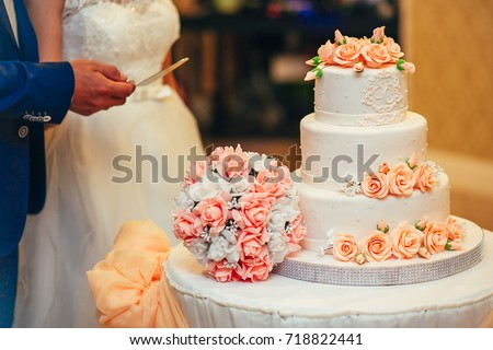 peach color big wedding cake stands at the table, wedding Royalty-Free Stock Photo #718822441
