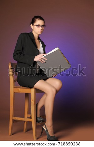 Young secretary or business woman with folders of paper