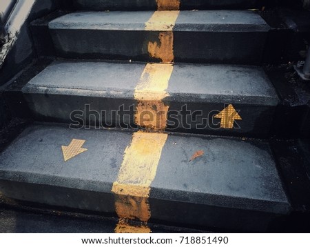 staircase with up and down arrow signs on the ground, for any work about construction, people's, life, business, and abstract concept background.
 Royalty-Free Stock Photo #718851490