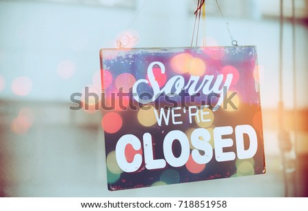 Closed sign hanging front of mirror door coffee shop double exposure with colorful bokeh light abstract background. Food drink and business service concept. Vintage tone filter color effect style.