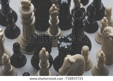 Chess game pieces on a grey background. Strategy concept