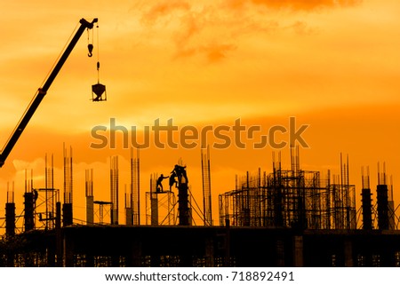 Silhouette crane, workers and engineer working on construction building site.