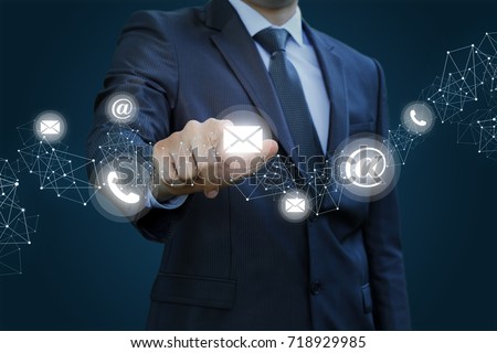 Businessman clicks on the letter. Concept contact us. Royalty-Free Stock Photo #718929985