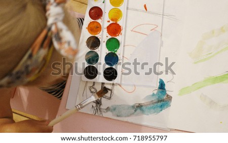 Kid painting with water colors