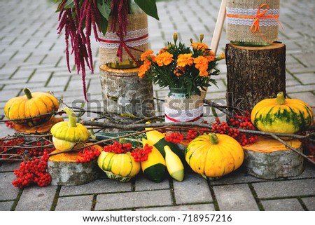 Fall composition with peasants, flowers and pumpkins