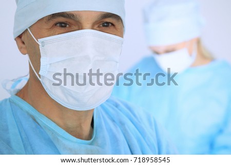 Boss surgeon is examining the operation while medical team are busy of patient. Medicine, healthcare and emergency in hospital